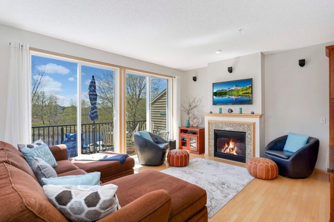 Living room with gas fireplace and tons of natural light | Image 4