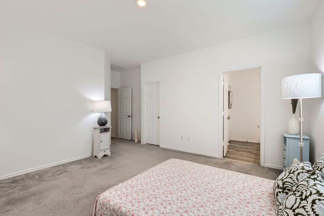 Bedroom featuring light carpet and baseboards | Image 16