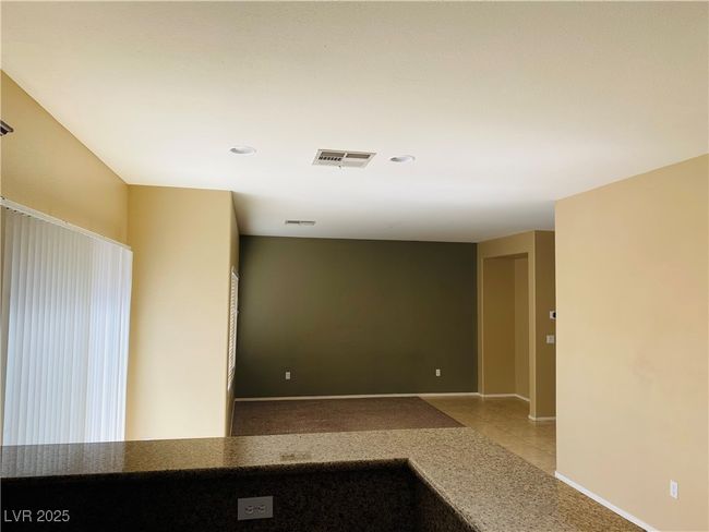 Empty room featuring tile patterned floors, visible vents, and baseboards | Image 11