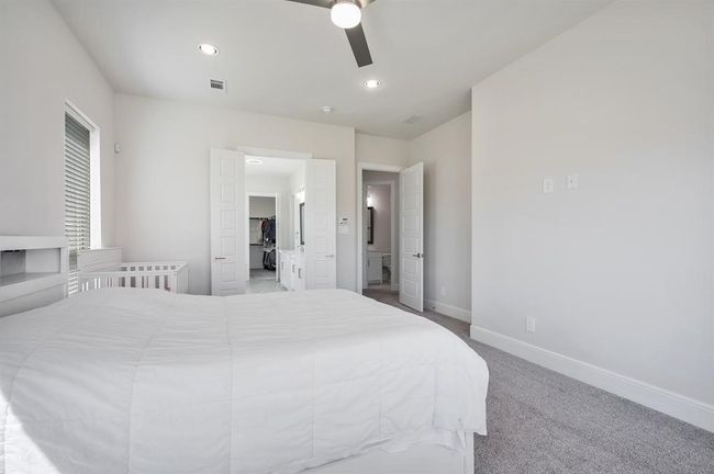 Bedroom featuring baseboards, carpet floors, a ceiling fan, a spacious closet, and recessed lighting | Image 15