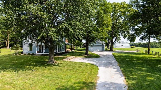 View of front of house with a garage, a front lawn, and an outdoor structure | Image 19