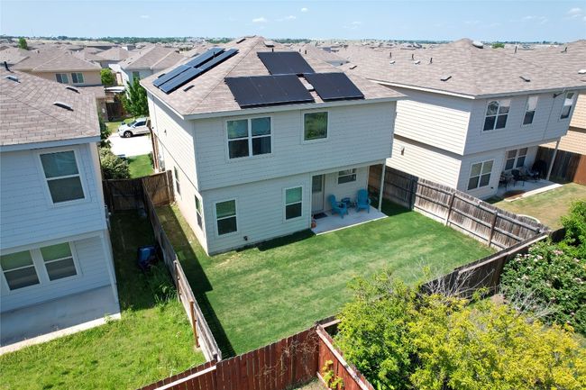 Back of house featuring solar panels, a patio area | Image 17