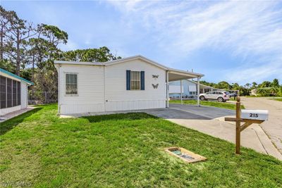 View of front facade with a front lawn and a carport | Image 3