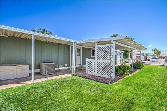Back of property featuring central AC and a yard | Image 32