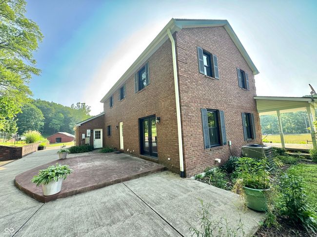 back of property with a patio area, central AC unit, brick siding, and french doors | Image 7