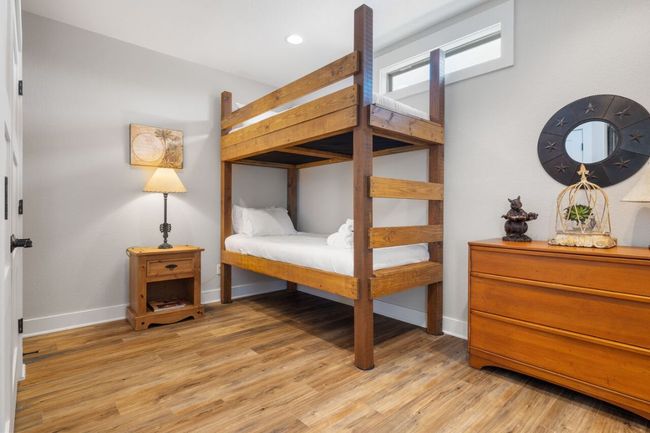 Bedroom with baseboards and light wood-style flooring | Image 39