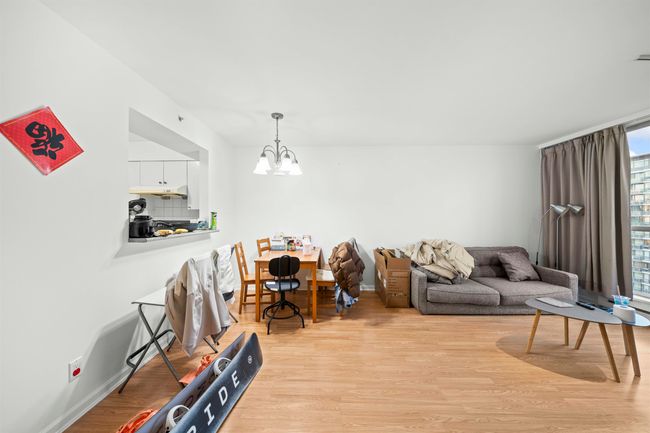 Living area featuring light wood-style flooring, baseboards, and a notable chandelier | Image 12