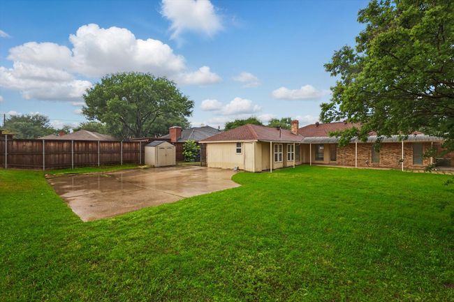 Rear view of property with a storage shed and a chimney | Image 24
