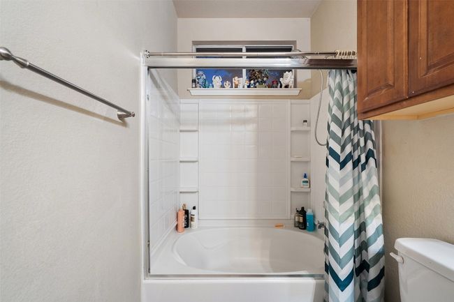 Spacious primary suite on the back of the house for added privacy offers a walk in closet, dual vanities, linen closet plus a window over the shower and tub providing natural light. | Image 26