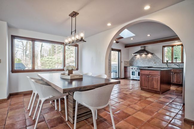 Dining area featuring baseboards, arched walkways, and recessed lighting | Image 5