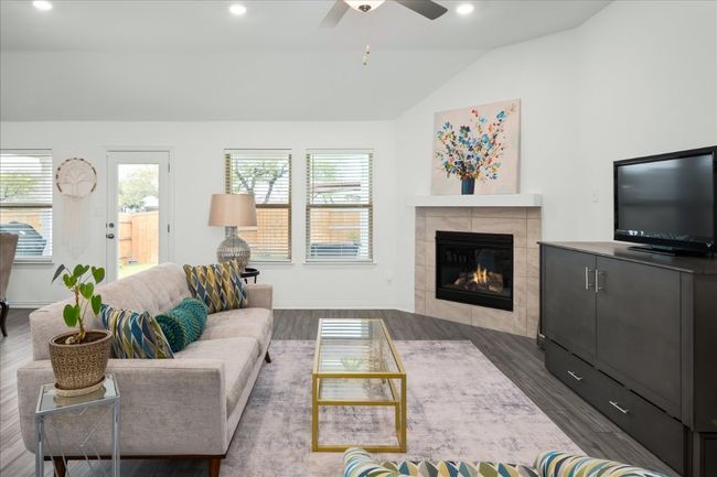 Living room with recessed lighting, wood finished floors, a fireplace, and vaulted ceiling | Image 6