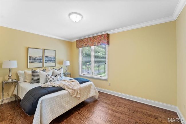 Bedroom featuring ornamental molding and wood finished floors | Image 33