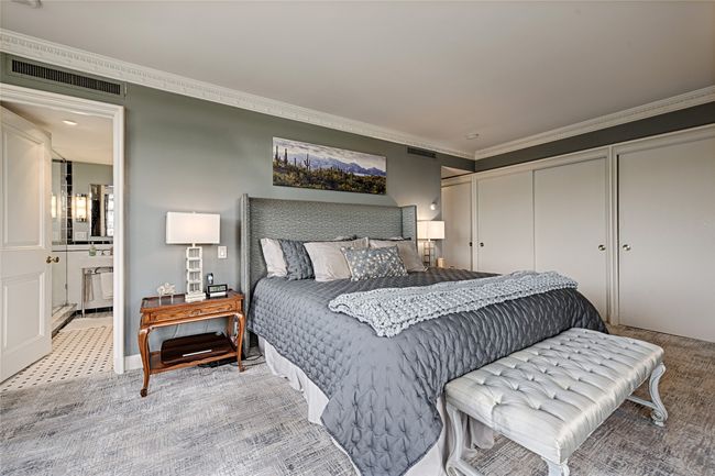 Owners suite with crown molding, ensuite bathroom, closets, and light colored carpet | Image 12