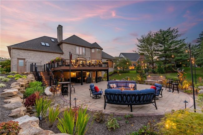 Here is another rear view of the home. Look at this and see the back patio, back deck and notice the all brick home and skylights. | Image 44