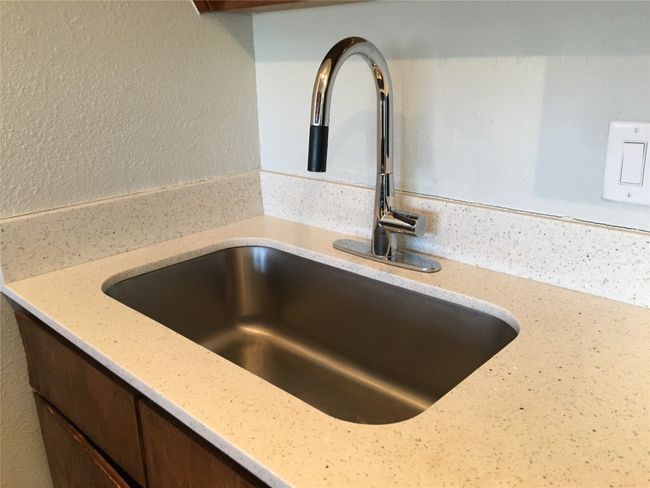 Interior details with a sink, light stone countertops, and dark brown cabinets | Image 11
