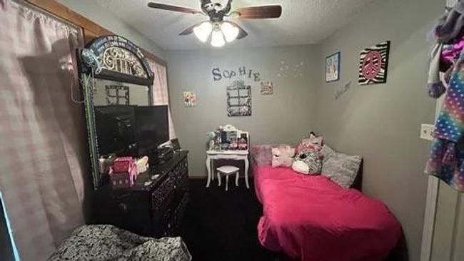 Bedroom with a textured ceiling and ceiling fan | Image 15