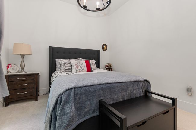Bedroom featuring light carpet and a chandelier | Image 18