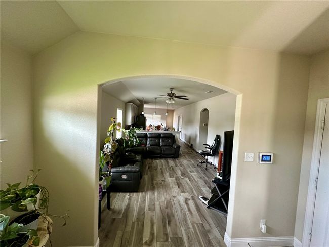 Hall featuring arched walkways and wood finished floors | Image 7