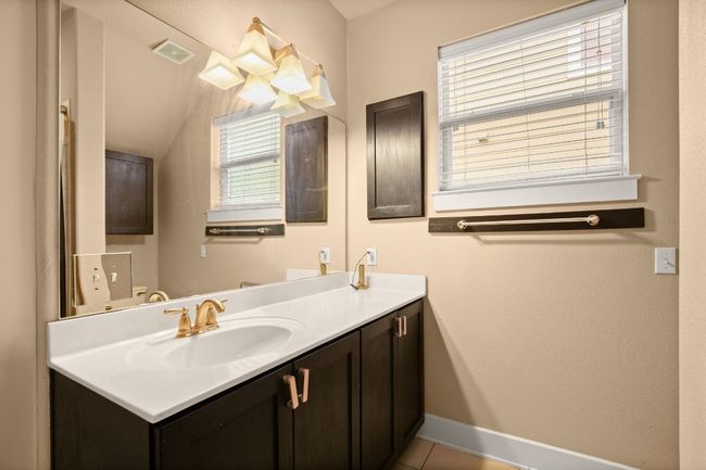 Bathroom with tile patterned floors, visible vents, vanity, and baseboards | Image 8