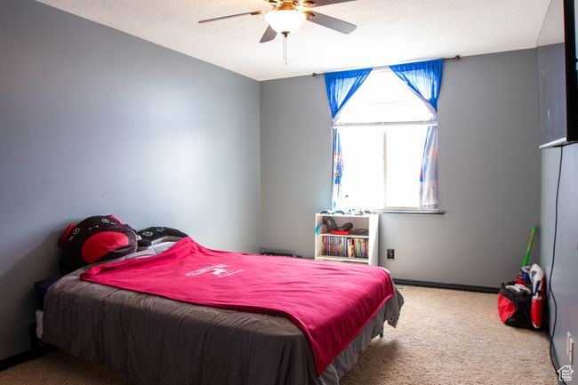 Carpeted bedroom featuring, a ceiling fan, and baseboards, large closet | Image 16