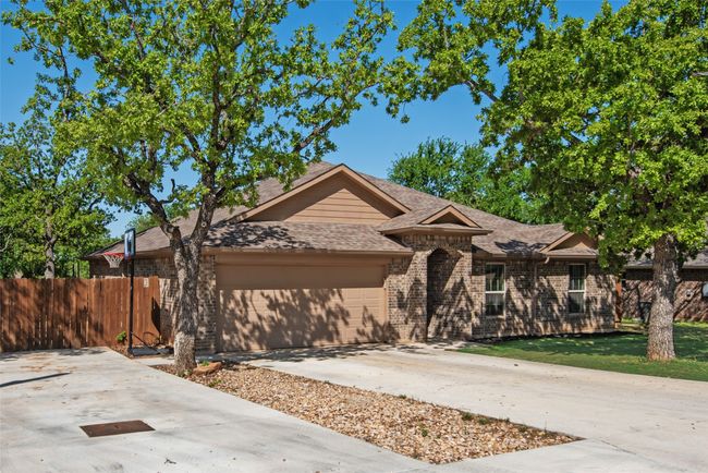 Single story home with a front yard, a shingled roof, an attached garage, fence, and concrete driveway | Image 5