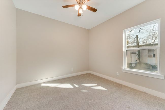 Carpeted spare room featuring a ceiling fan and cooling unit | Image 19