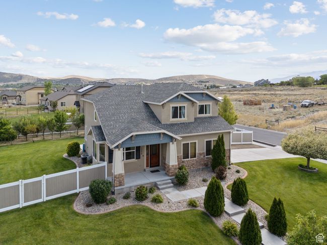 Craftsman house with stone siding, stucco siding, a mountain view, a shingled roof, and a porch | Image 52