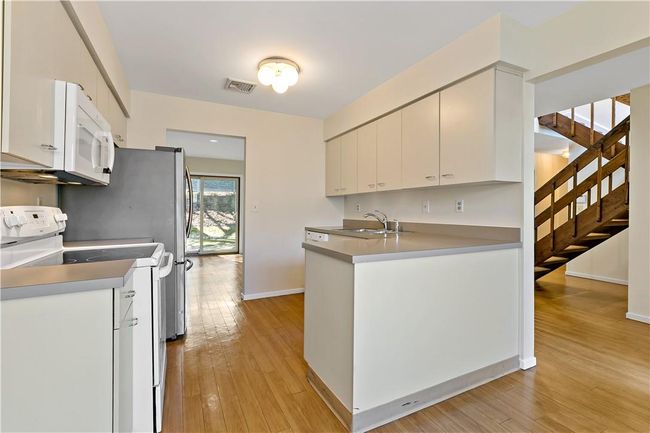 Kitchen open to the hall on right and formal dining room. | Image 9