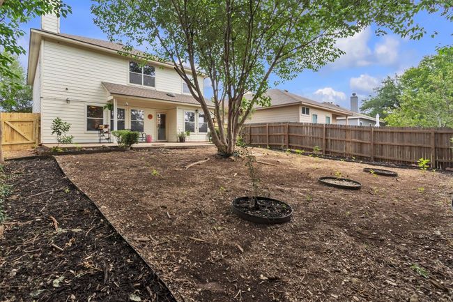 Alternate view of the backyard, you can see the new portion of the fence to the left, compared to the original fence to the right, again we didn't have the money to replace the grass in the back but we did have the trees trimmed, roof replaced May of 2025 | Image 27