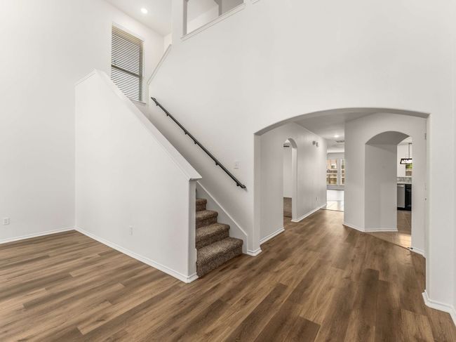 Entrance foyer with wood finished floors, a towering ceiling, arched walkways, and recessed lighting | Image 6
