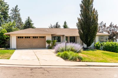 Single story home with a garage and a front yard | Image 1