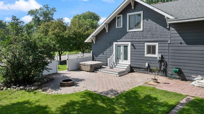 710 SF semi-private patio space just off the living room with a brick firepit | Image 9