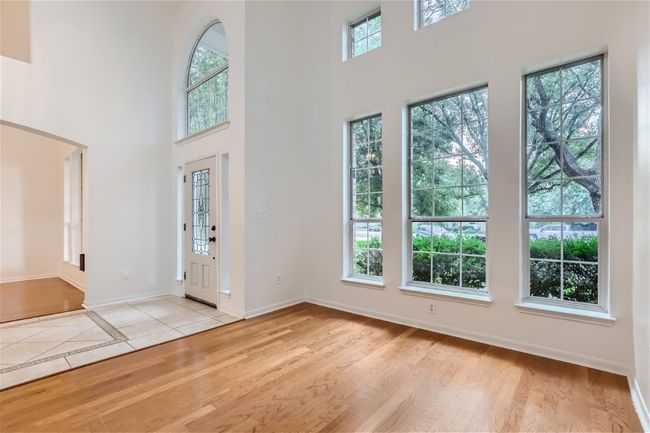 Entryway featuring a towering ceiling, baseboards, and light wood-style floors | Image 4