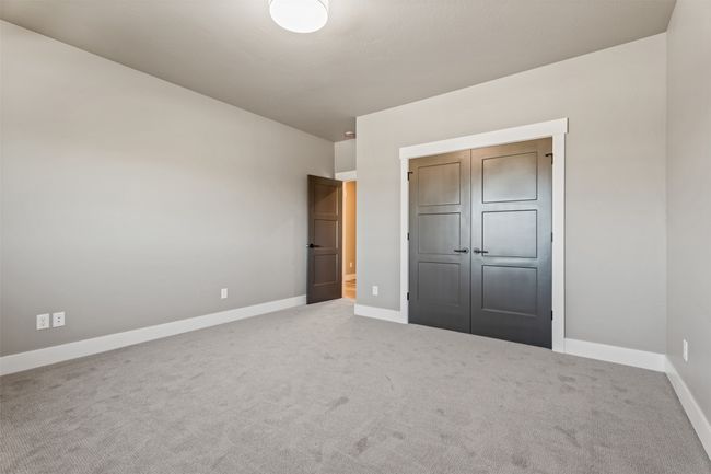 Unfurnished bedroom with baseboards, carpet flooring, and a closet | Image 29