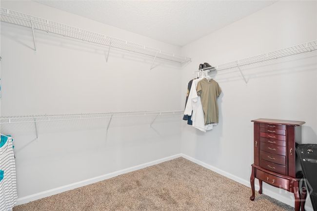 Walk in closet with built in shelving. | Image 27