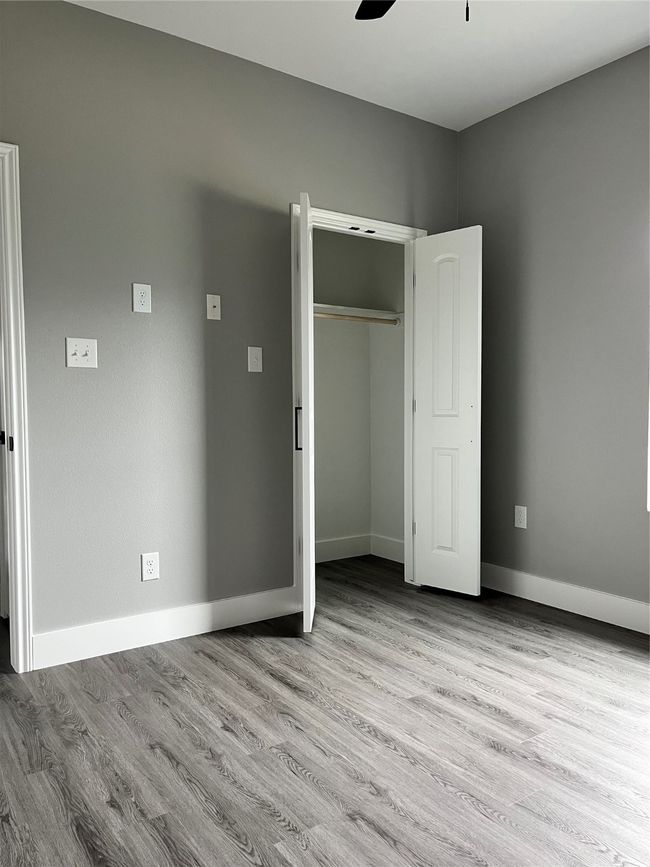 Unfurnished bedroom with wood finished floors, a closet, and ceiling fan | Image 19