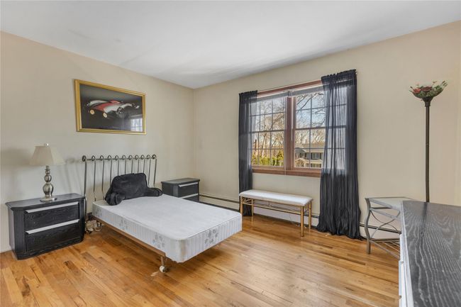Bedroom with a baseboard radiator and hardwood / wood-style flooring | Image 17