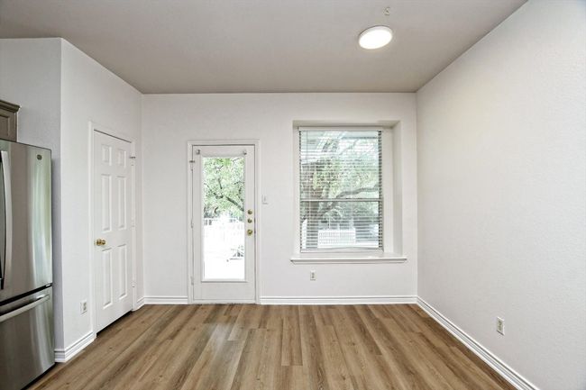 Doorway with light wood-type flooring and baseboards | Image 5