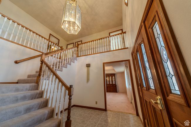 Stairs with plenty of natural light, baseboards, a high ceiling, and carpet | Image 17
