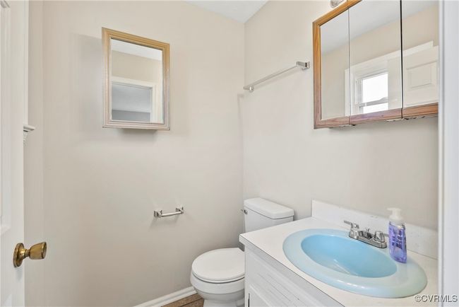 Half bathroom with baseboards, toilet, and vanity | Image 20