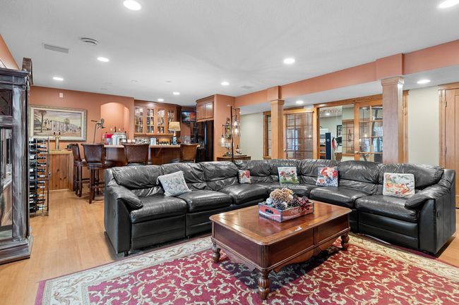 Lower-level recreation room viewed looking toward wet bar and exercise room. | Image 42