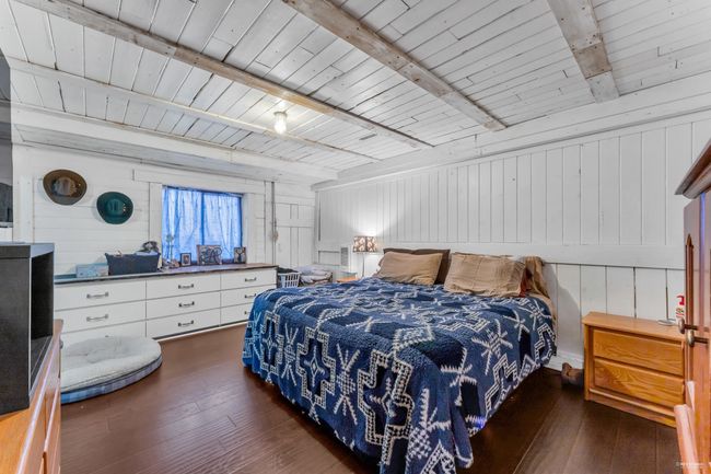 Bedroom featuring wood ceiling, beamed ceiling, and dark wood-style flooring | Image 26