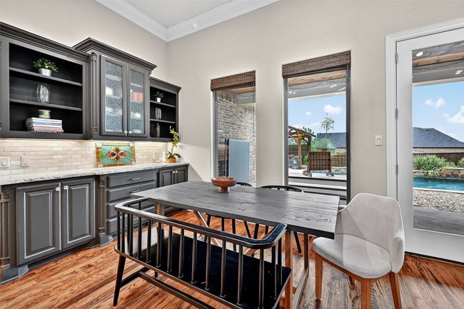 Dining room featuring crown molding, light wood-style flooring, and plenty of natural light | Image 11