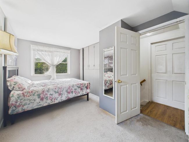 Carpeted bedroom with a closet | Image 18