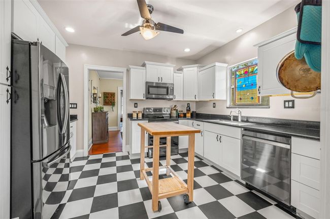 Kitchen with granite counters and stainless steel appliances. | Image 15