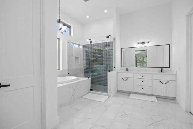 Full bathroom with a garden tub, double vanity, a shower stall, healthy amount of natural light, and recessed lighting | Image 15