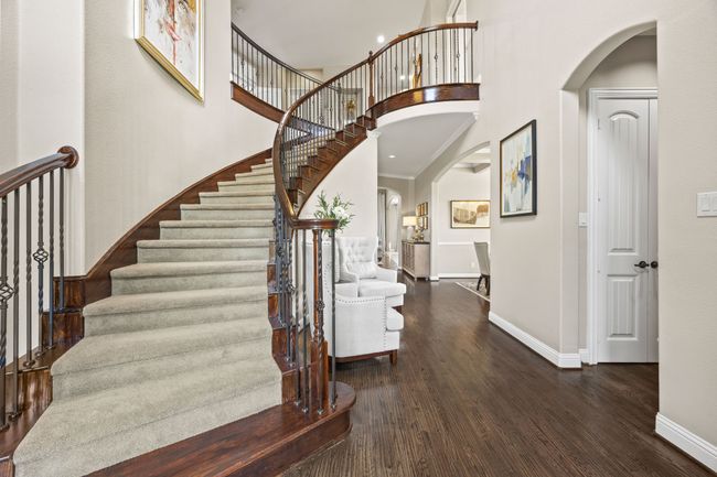 Grand staircase at the front entry- home office and half bath to the immediate right, formal dining room just beyond leading to the livingroom and kitchen. | Image 8