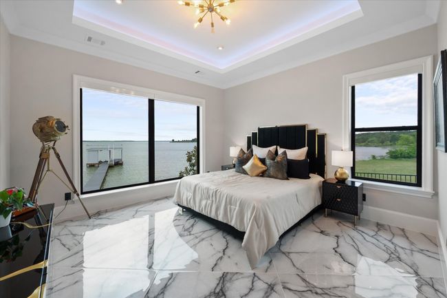 Bedroom with visible vents, a raised ceiling, multiple windows, and an inviting chandelier | Image 21