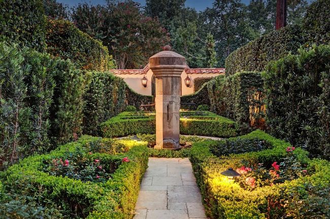 Rose garden on the westside has wonderful fountain and landscape lighting. There is also a door off the garden that leads to the kitchen. Both entrances are gated. | Image 45