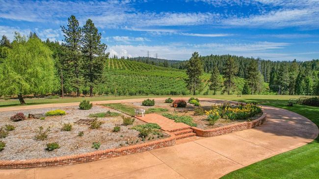 Circular driveway with brick wall. | Image 42